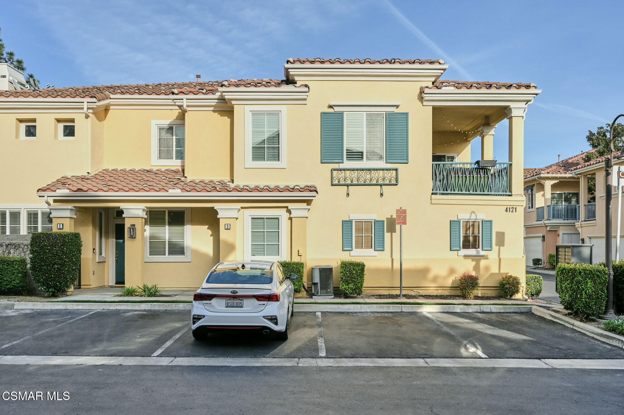4121 Paredo Way, Unit D Simi Valley, CA 93063 - Photo 25 of 29 front view of a house with a cars parked on road