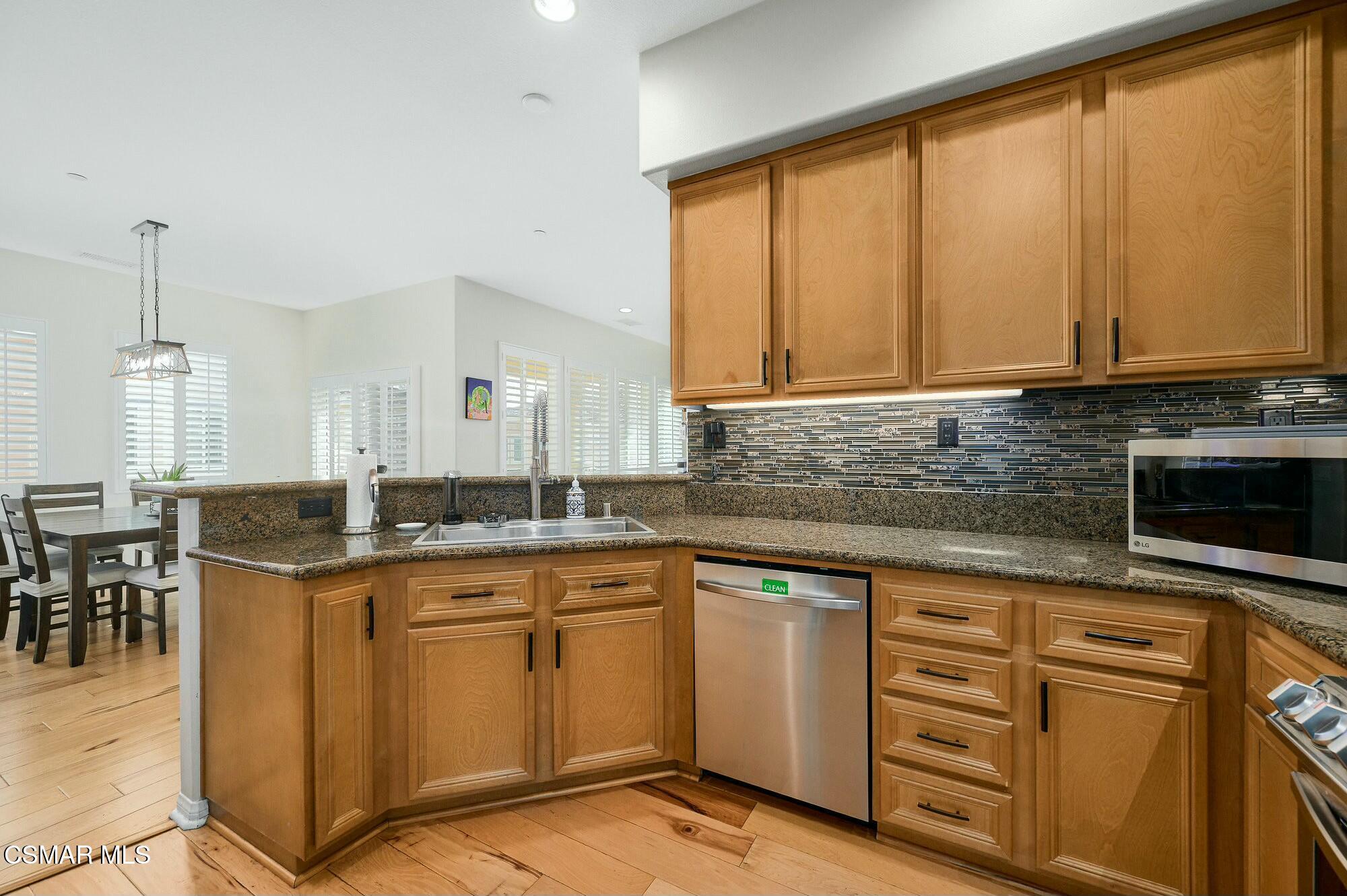 4121 Paredo Way, Unit D Simi Valley, CA 93063 - Photo 7 of 29 a kitchen with granite countertop cabinets stainless steel appliances a sink and a window