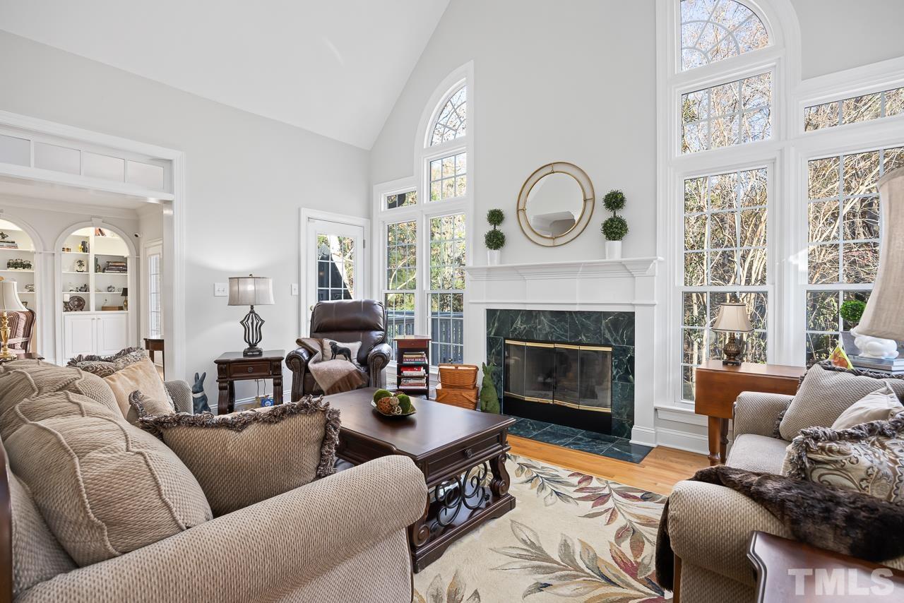 8712 Bell Grove Way Raleigh, NC 27615 - Photo 13 of 42 a living room with furniture a fireplace and a large window