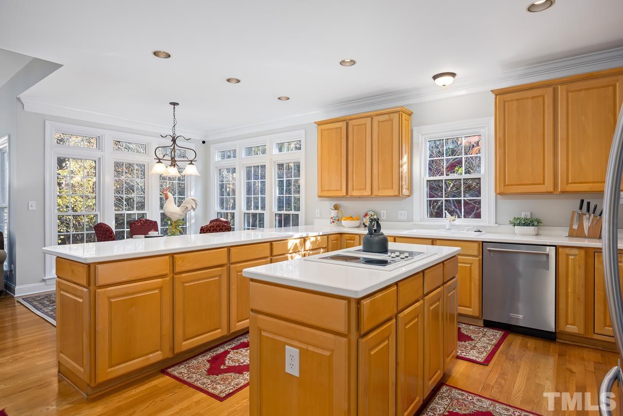 8712 Bell Grove Way Raleigh, NC 27615 - Photo 17 of 42 a kitchen with granite countertop a sink stove and cabinets