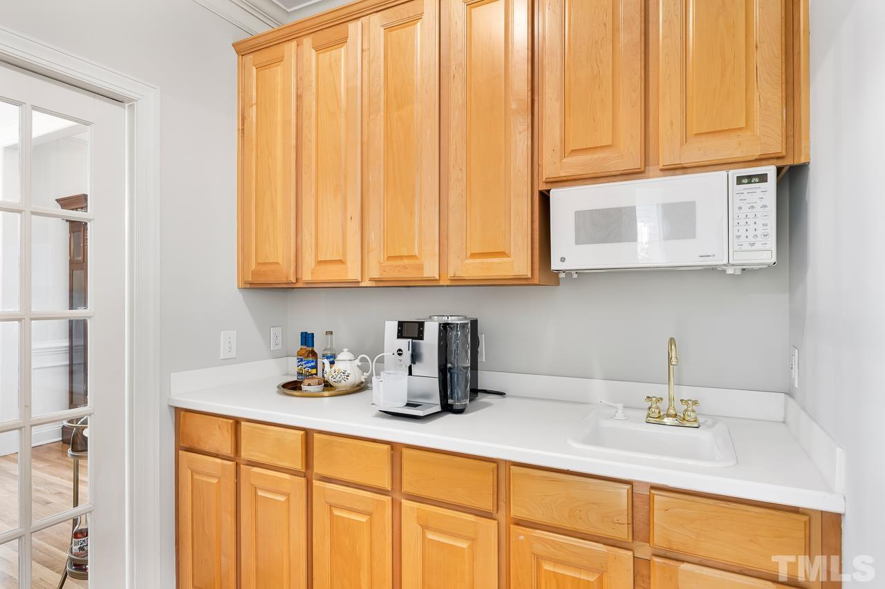 8712 Bell Grove Way Raleigh, NC 27615 - Photo 18 of 42 a kitchen with stainless steel appliances granite countertop white cabinets a sink and dishwasher
