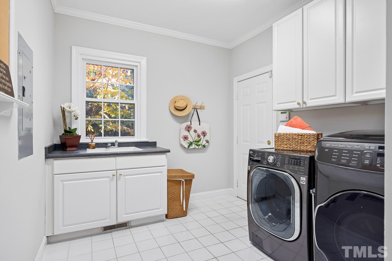 8712 Bell Grove Way Raleigh, NC 27615 - Photo 20 of 42 a utility room with sink dryer and washer