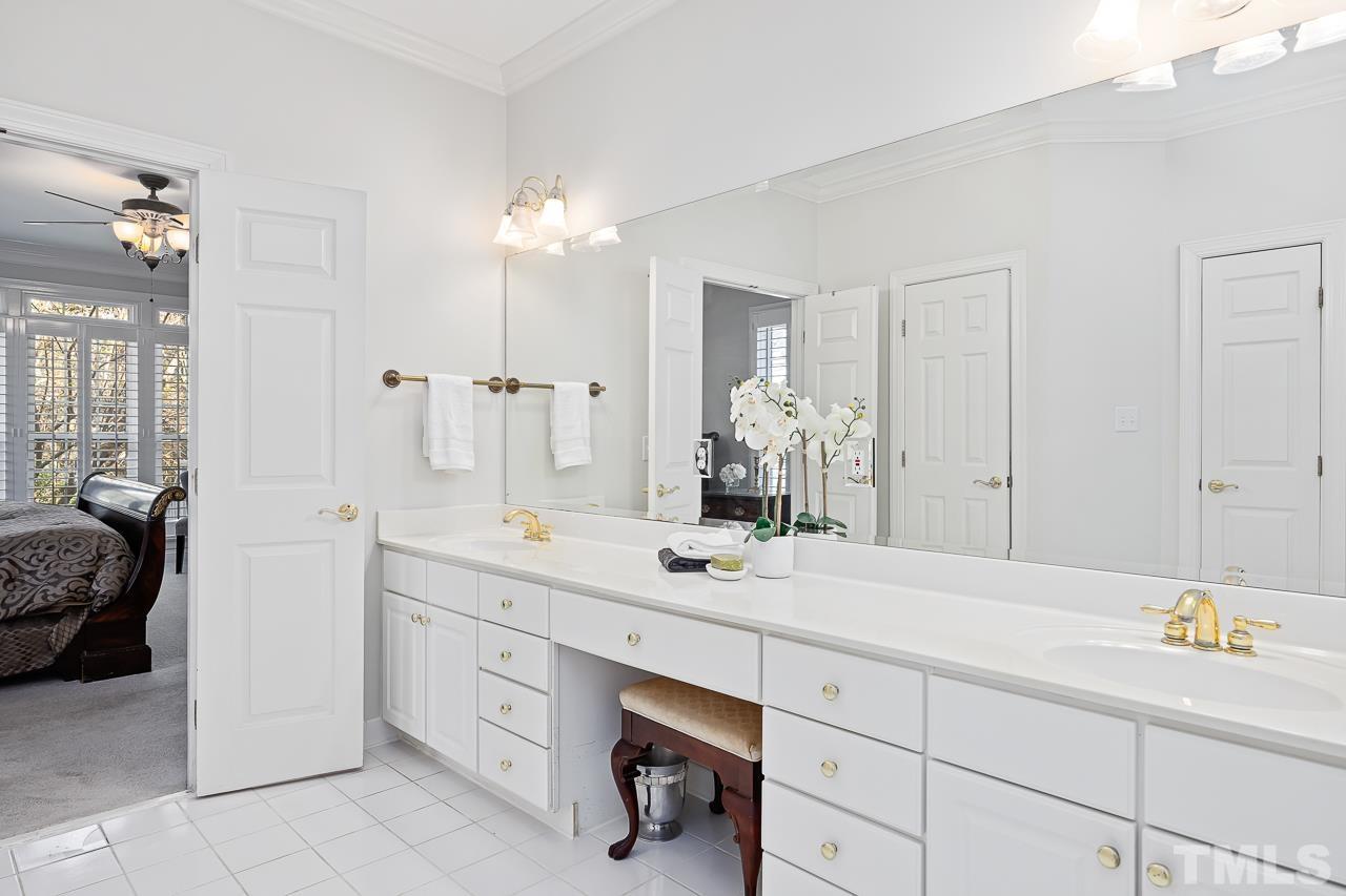 8712 Bell Grove Way Raleigh, NC 27615 - Photo 25 of 42 a spacious bathroom with a granite countertop sink mirror and bathtub