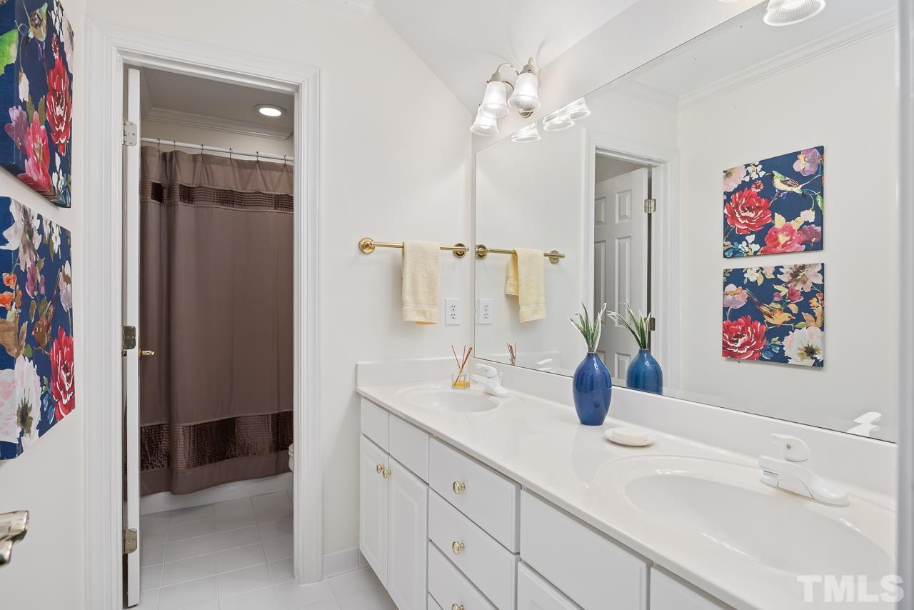 8712 Bell Grove Way Raleigh, NC 27615 - Photo 27 of 42 a bathroom with a sink and a mirror