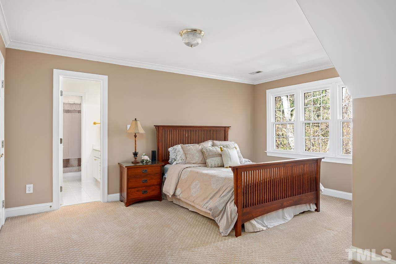 8712 Bell Grove Way Raleigh, NC 27615 - Photo 28 of 42 a bed sitting in a bedroom next to a window