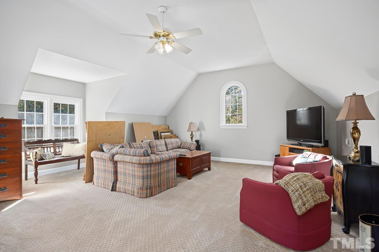 8712 Bell Grove Way Raleigh, NC 27615 - Photo 29 of 42 a living room with furniture and a flat screen tv