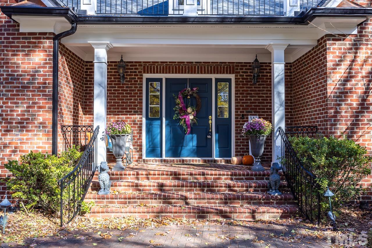 8712 Bell Grove Way Raleigh, NC 27615 - Photo 4 of 42 a front view of a house with a porch