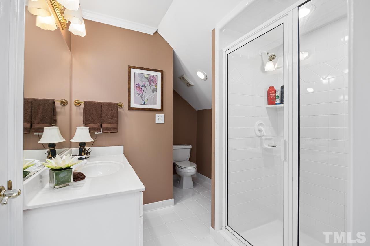 8712 Bell Grove Way Raleigh, NC 27615 - Photo 31 of 42 a bathroom with a sink a toilet and shower