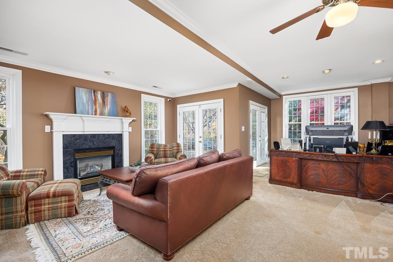 8712 Bell Grove Way Raleigh, NC 27615 - Photo 32 of 42 a living room with furniture and a fireplace