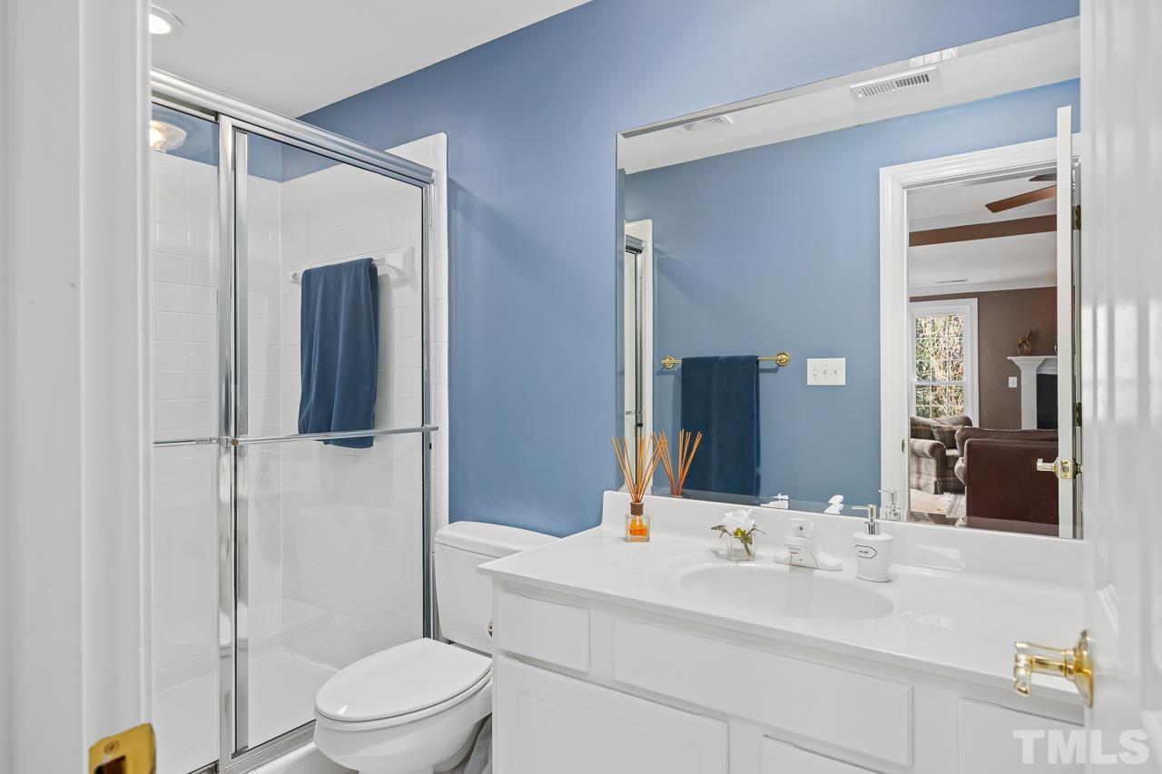 8712 Bell Grove Way Raleigh, NC 27615 - Photo 33 of 42 a bathroom with a sink a toilet and shower
