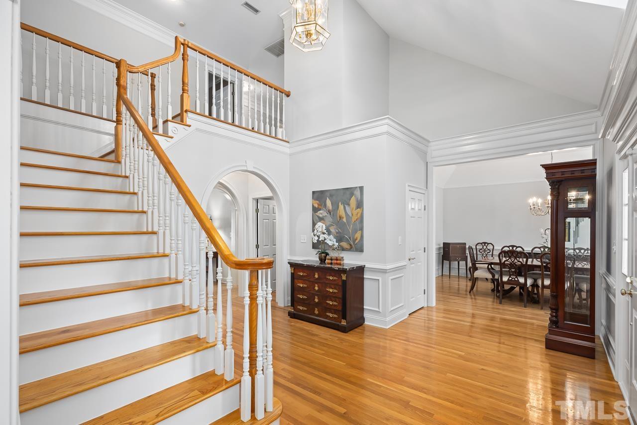 8712 Bell Grove Way Raleigh, NC 27615 - Photo 7 of 42 a view of entryway dining room and hall with wooden floor