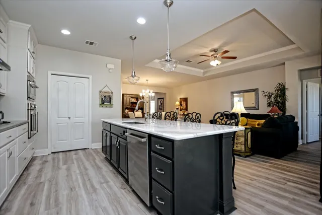 a large kitchen with stainless steel appliances a lot of counter space