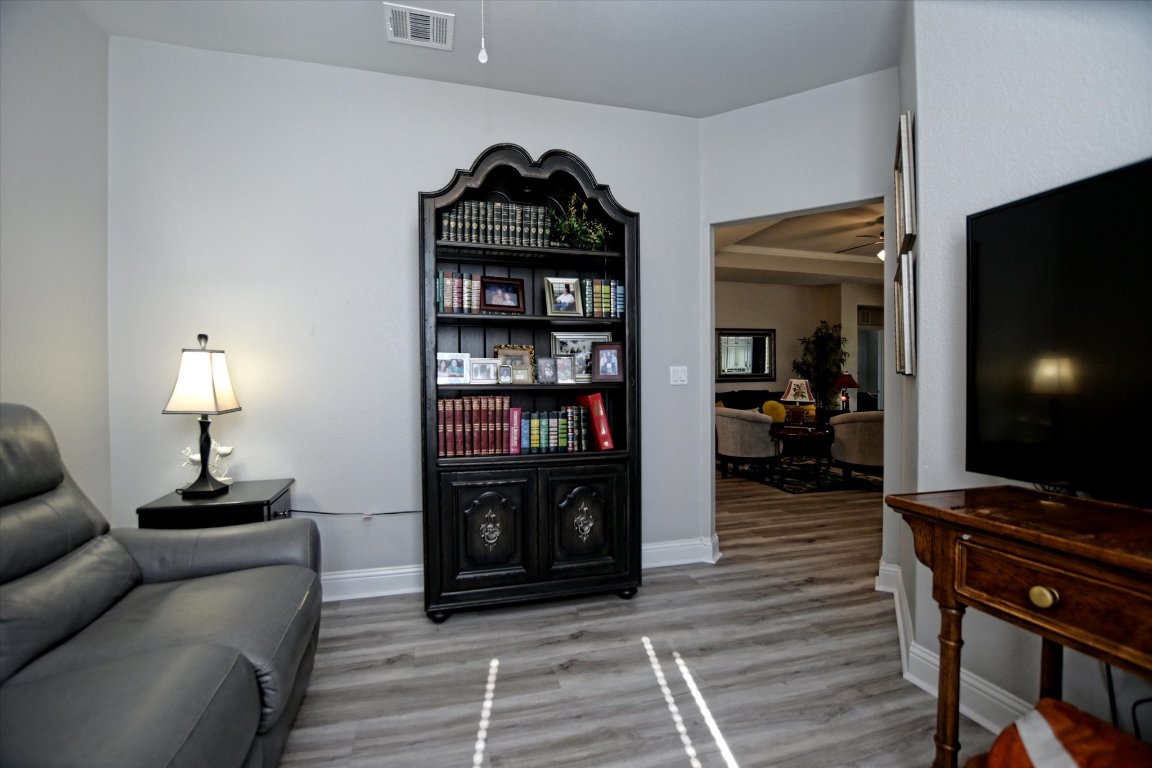 113 Cathedral Mountain Pass Georgetown, TX 78633 - Photo 15 of 29 a living room with furniture a piano and a flat screen tv