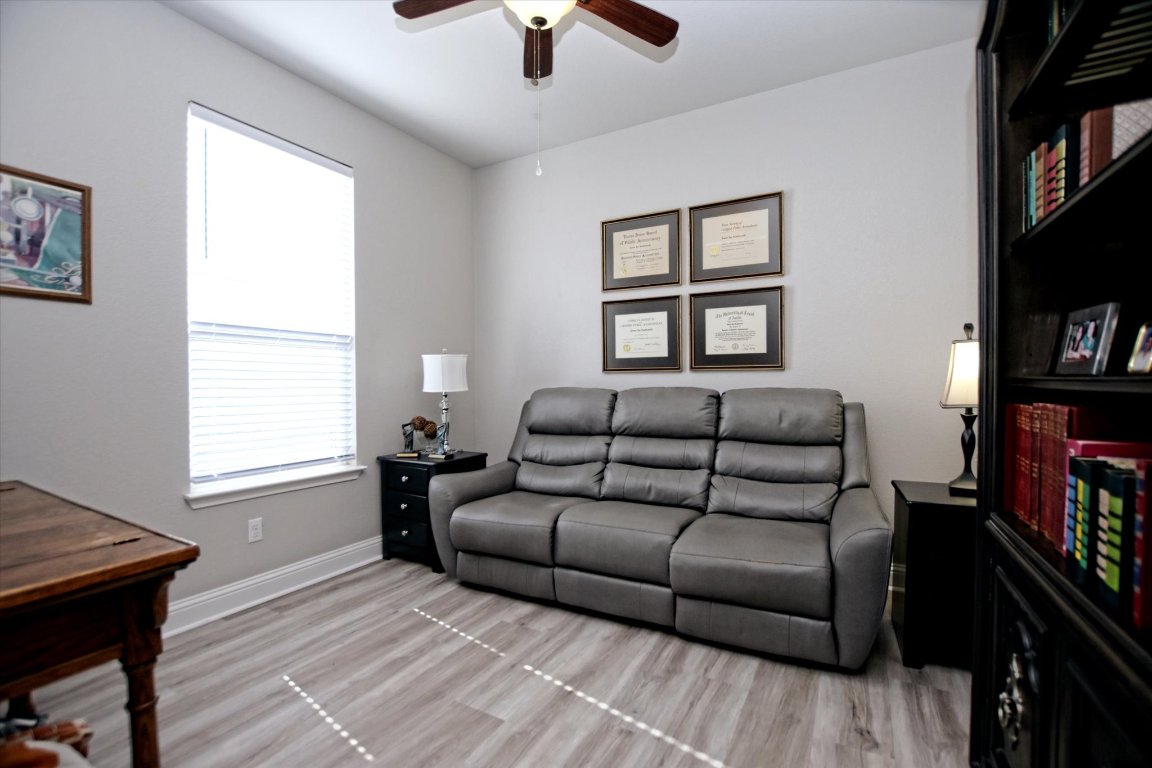 113 Cathedral Mountain Pass Georgetown, TX 78633 - Photo 16 of 29 a living room with furniture a flat screen tv and a window