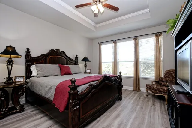 a bed room with a bed and a chandelier