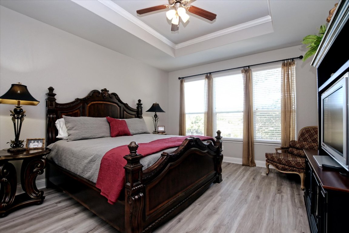 113 Cathedral Mountain Pass Georgetown, TX 78633 - Photo 17 of 29 a bed room with a bed and a chandelier