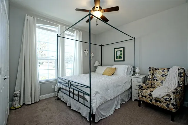 a bedroom with a bed and window