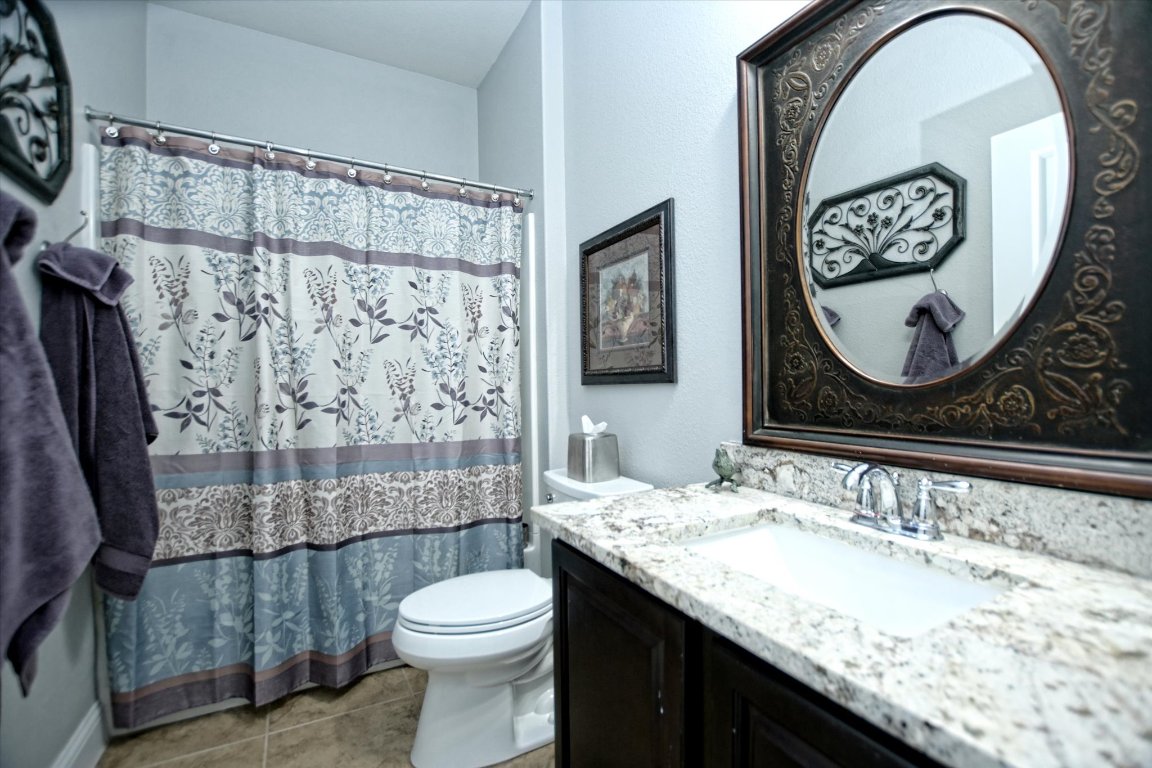113 Cathedral Mountain Pass Georgetown, TX 78633 - Photo 21 of 29 a bathroom with a granite countertop sink mirror vanity and toilet