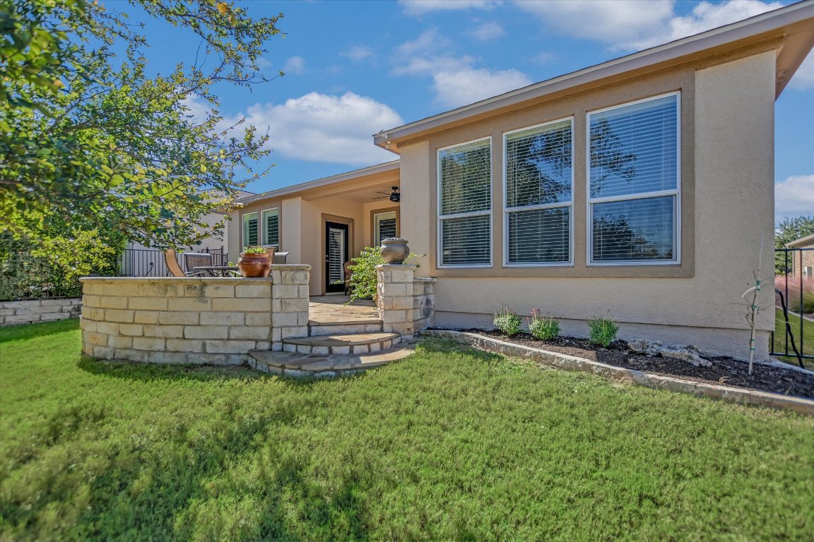 113 Cathedral Mountain Pass Georgetown, TX 78633 - Photo 27 of 29 a front view of a house with a garden