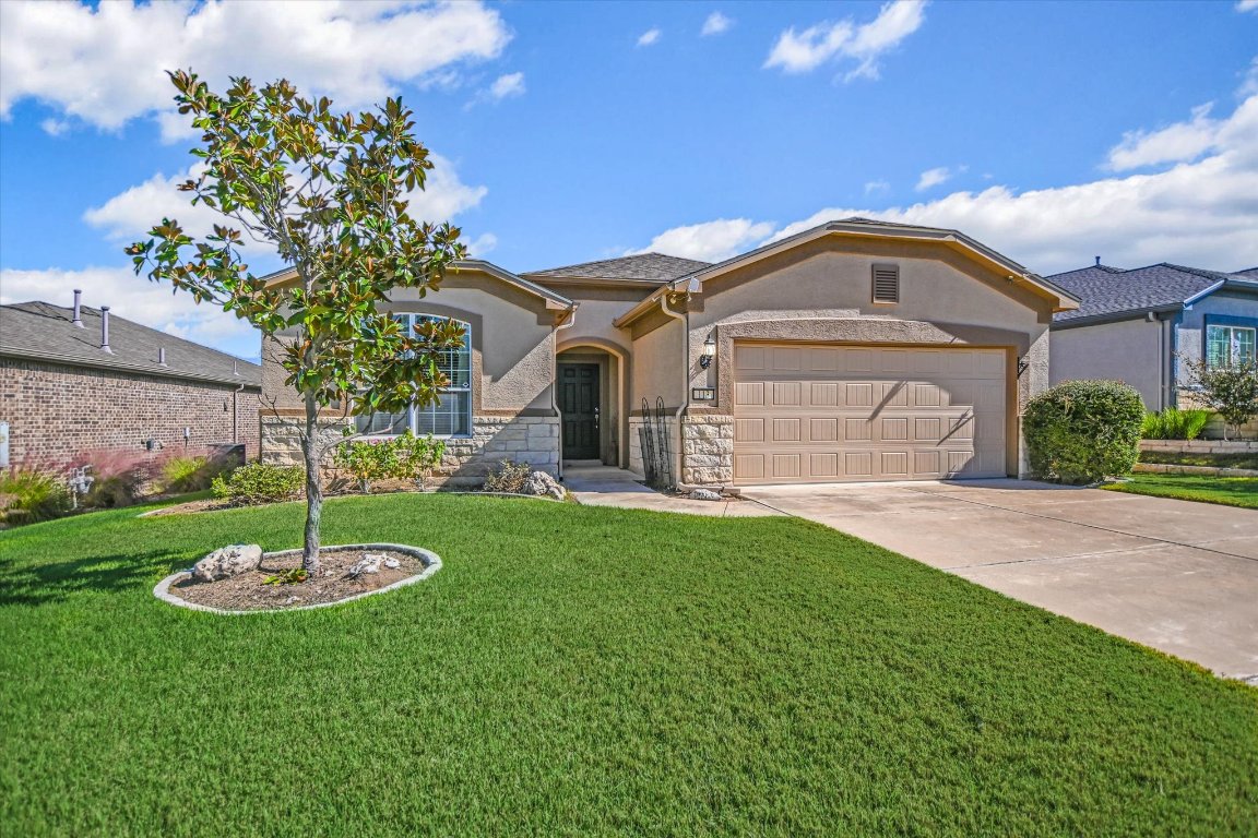 113 Cathedral Mountain Pass Georgetown, TX 78633 - Photo 3 of 29 a front view of a house with a garden