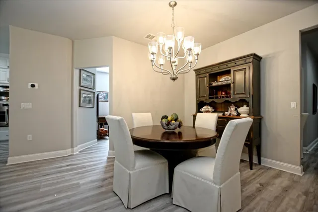 a view of a dining room with furniture and chandelier