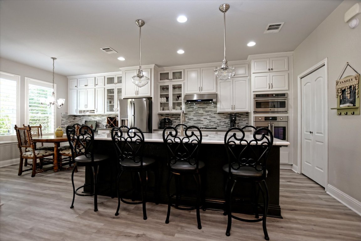 113 Cathedral Mountain Pass Georgetown, TX 78633 - Photo 10 of 29 a large kitchen with a table and chairs