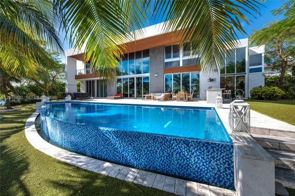 a view of a house with swimming pool and sitting area