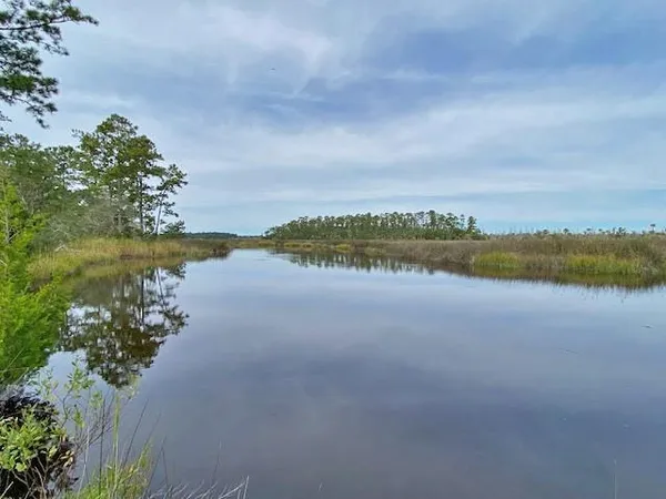 a view of a lake with houses in the back