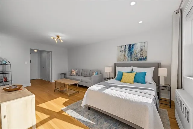 a bedroom with a bed and a view of kitchen