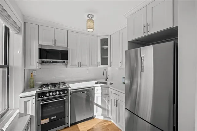 a kitchen with stainless steel appliances a refrigerator stove and microwave