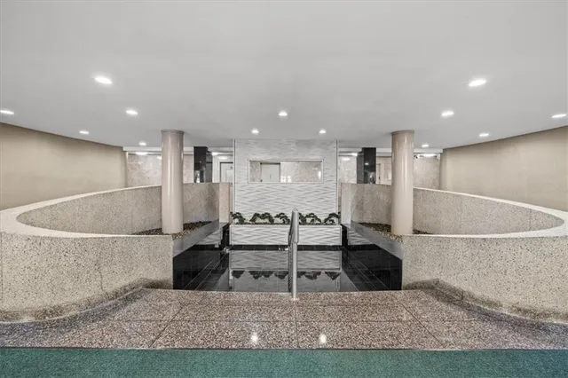 a view of kitchen with stainless steel appliances kitchen island a stove a table and chairs