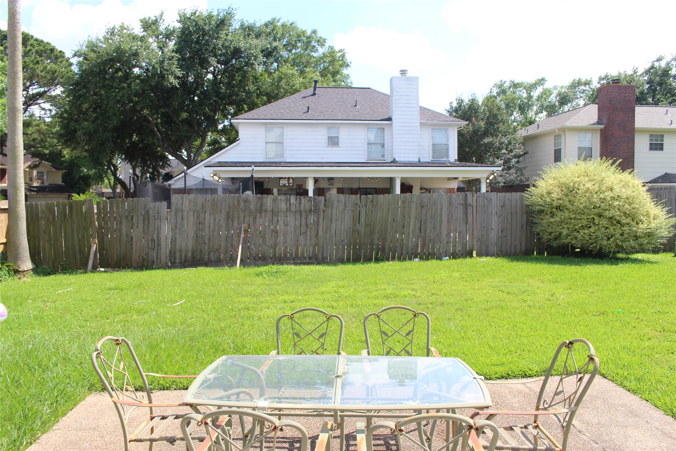4103 Sablemist Court Houston, TX 77014 - Photo 5 of 29 a view of a backyard with table and chairs with wooden fence