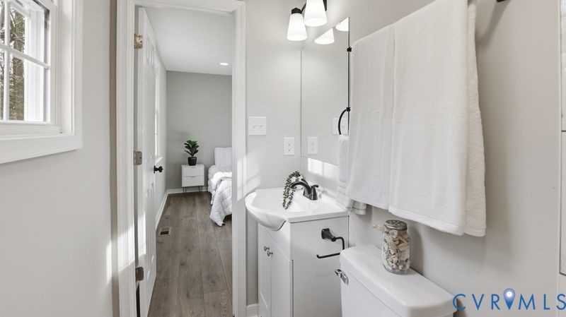 25209 Ritchie Avenue Petersburg, VA 23803 - Photo 25 of 50 a bathroom with a sink a toilet and shower curtain