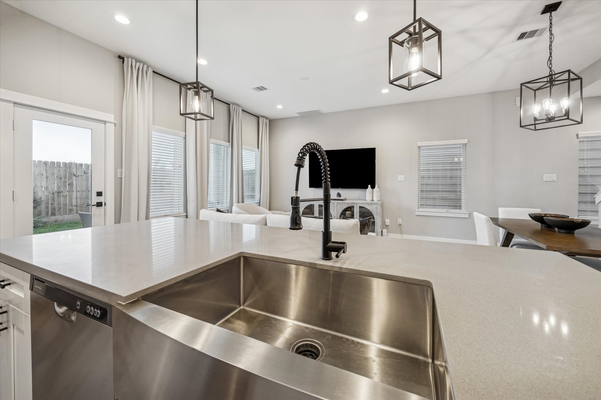 11327 Stonework Grove Lane Houston, TX 77076 - Photo 13 of 37 a kitchen with a center island appliances and a window