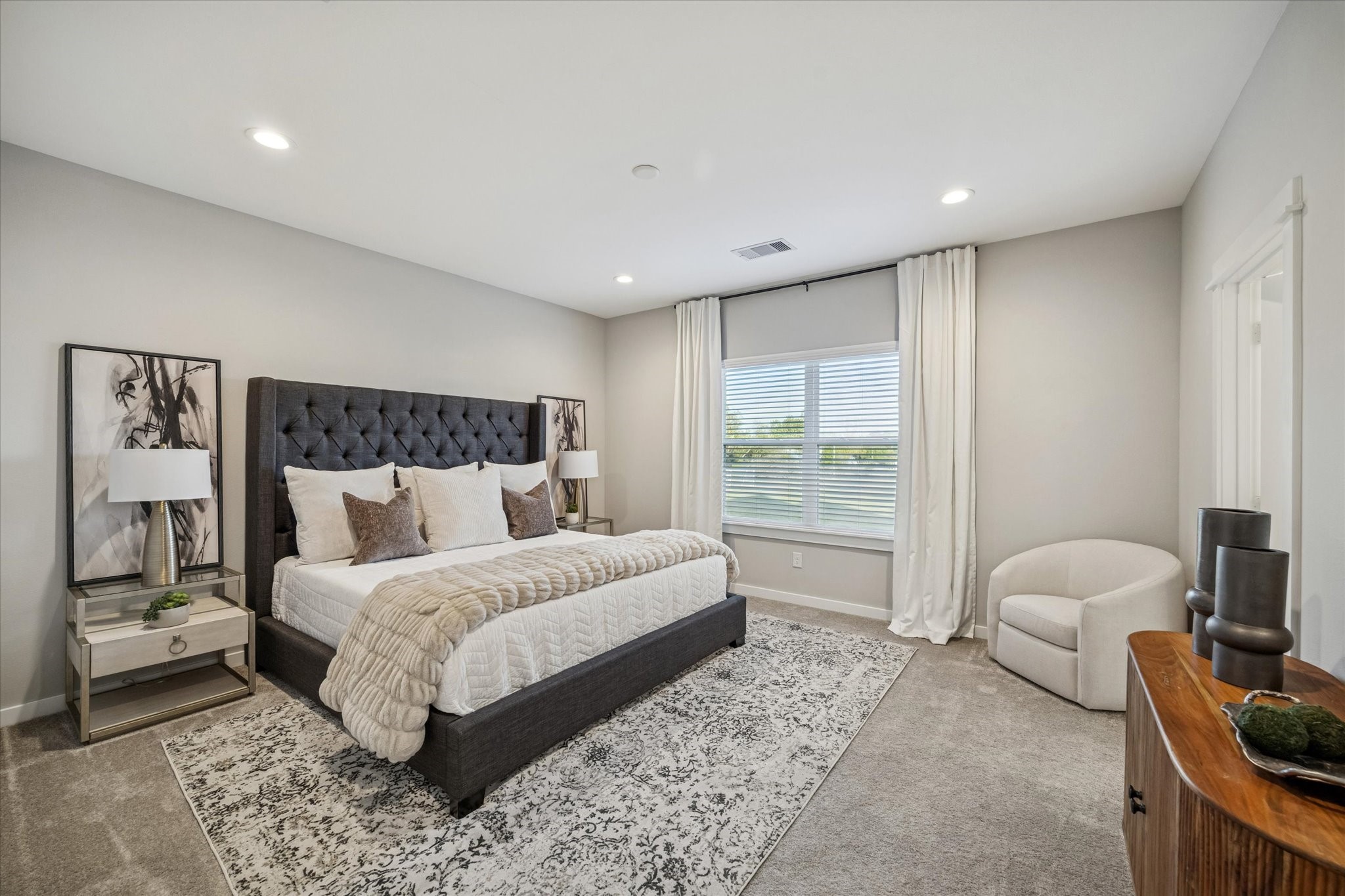 11327 Stonework Grove Lane Houston, TX 77076 - Photo 22 of 37 a spacious bedroom with a large bed and a couch
