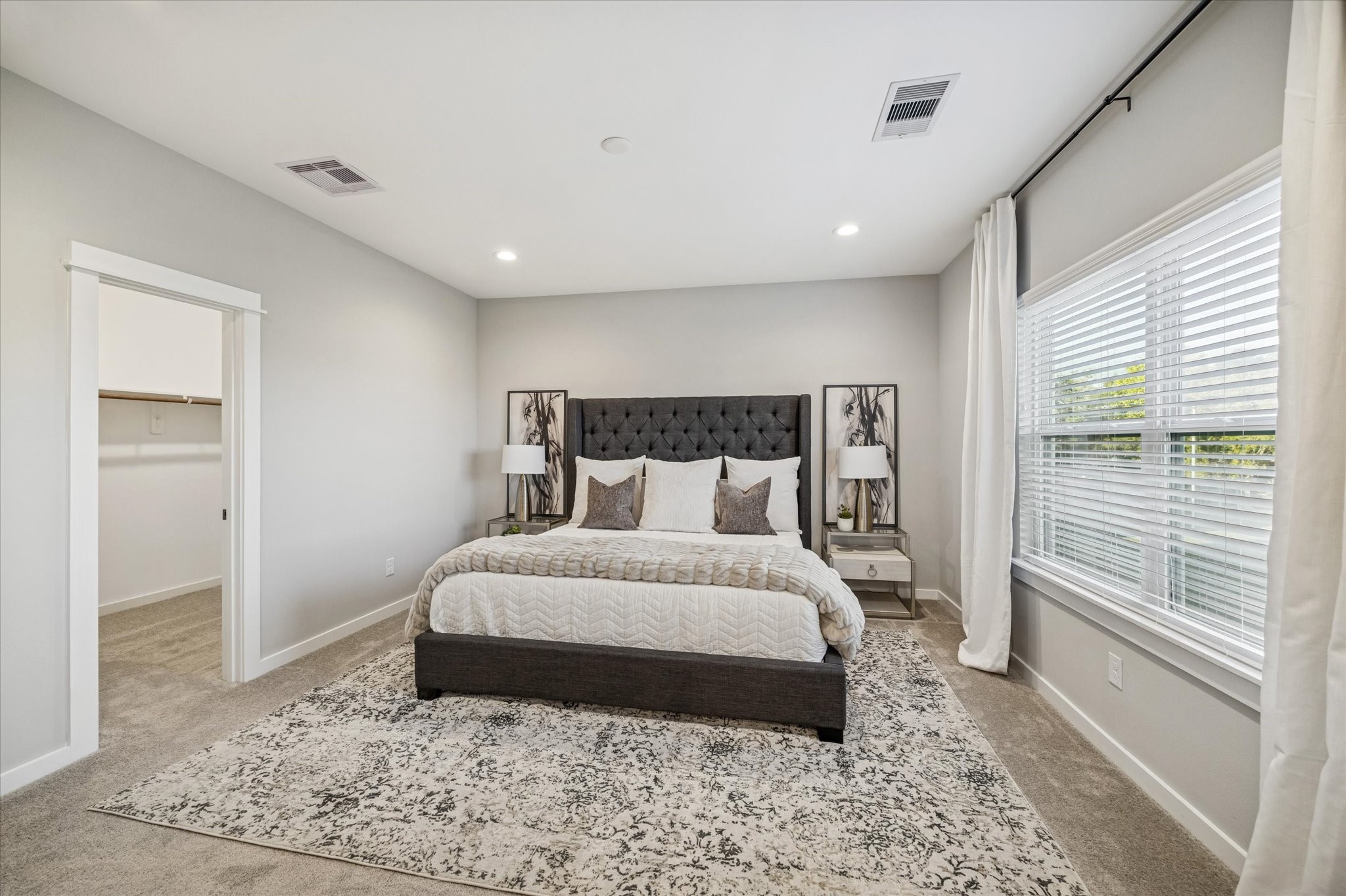 11327 Stonework Grove Lane Houston, TX 77076 - Photo 27 of 37 a large bedroom with a bed and wooden floor