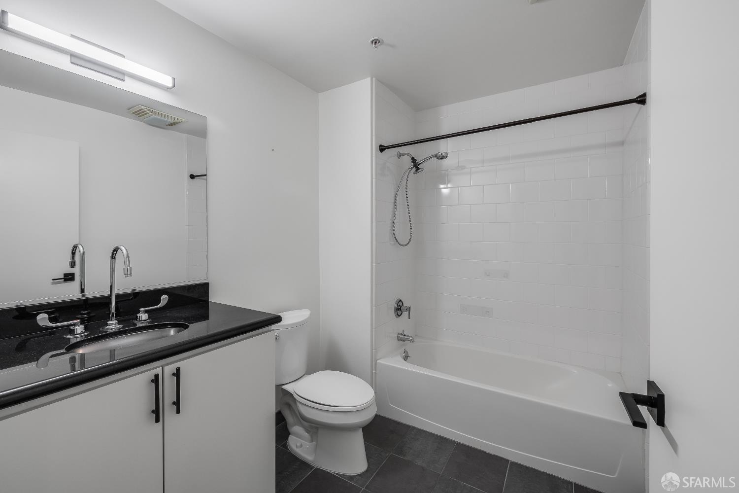 Harrison Street San Francisco, CA 94110 - Photo 11 of 26 a bathroom with a sink a toilet a mirror and shower