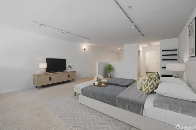 a bedroom with furniture and a flat screen tv