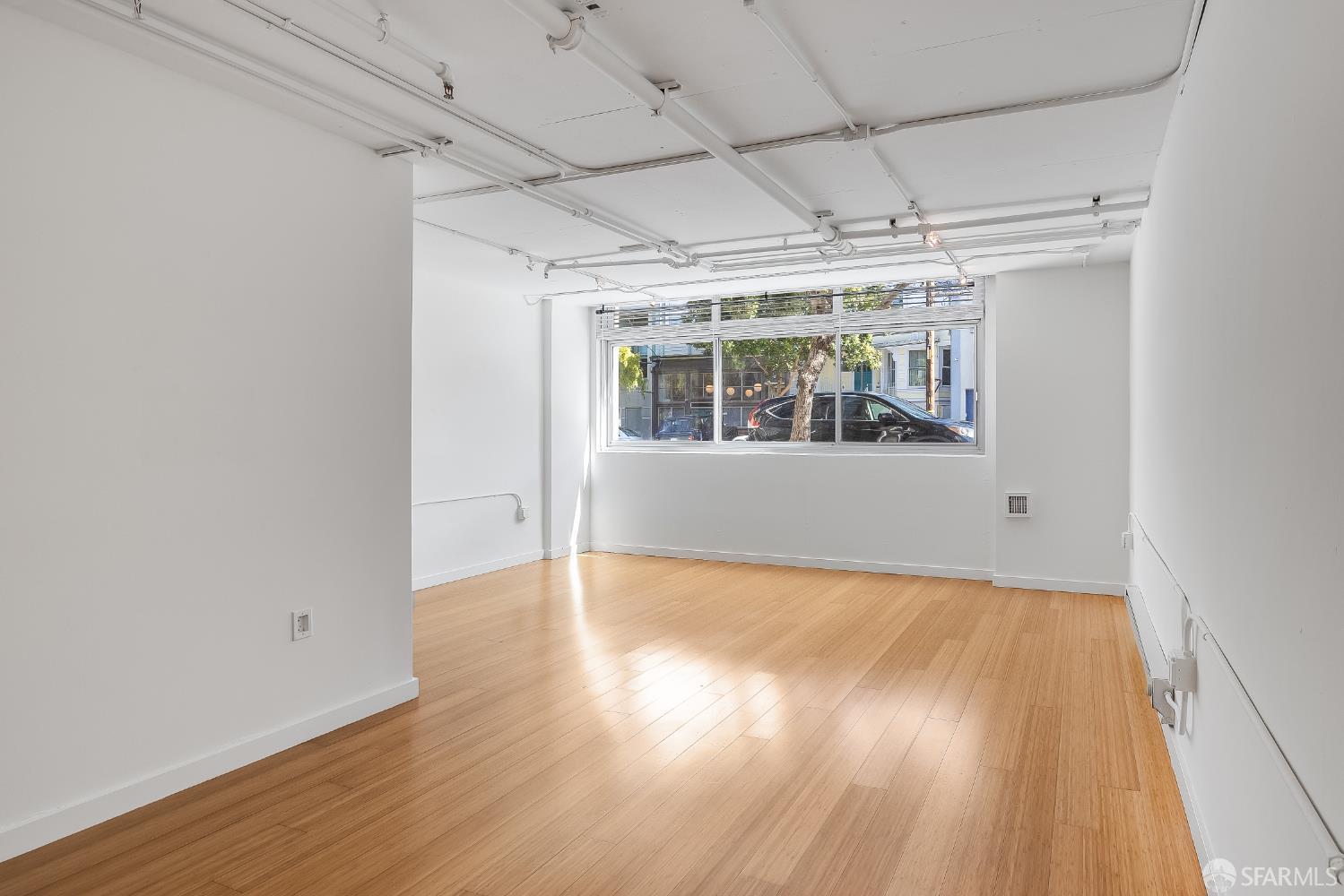 Harrison Street San Francisco, CA 94110 - Photo 20 of 26 an empty room with wooden floor and windows