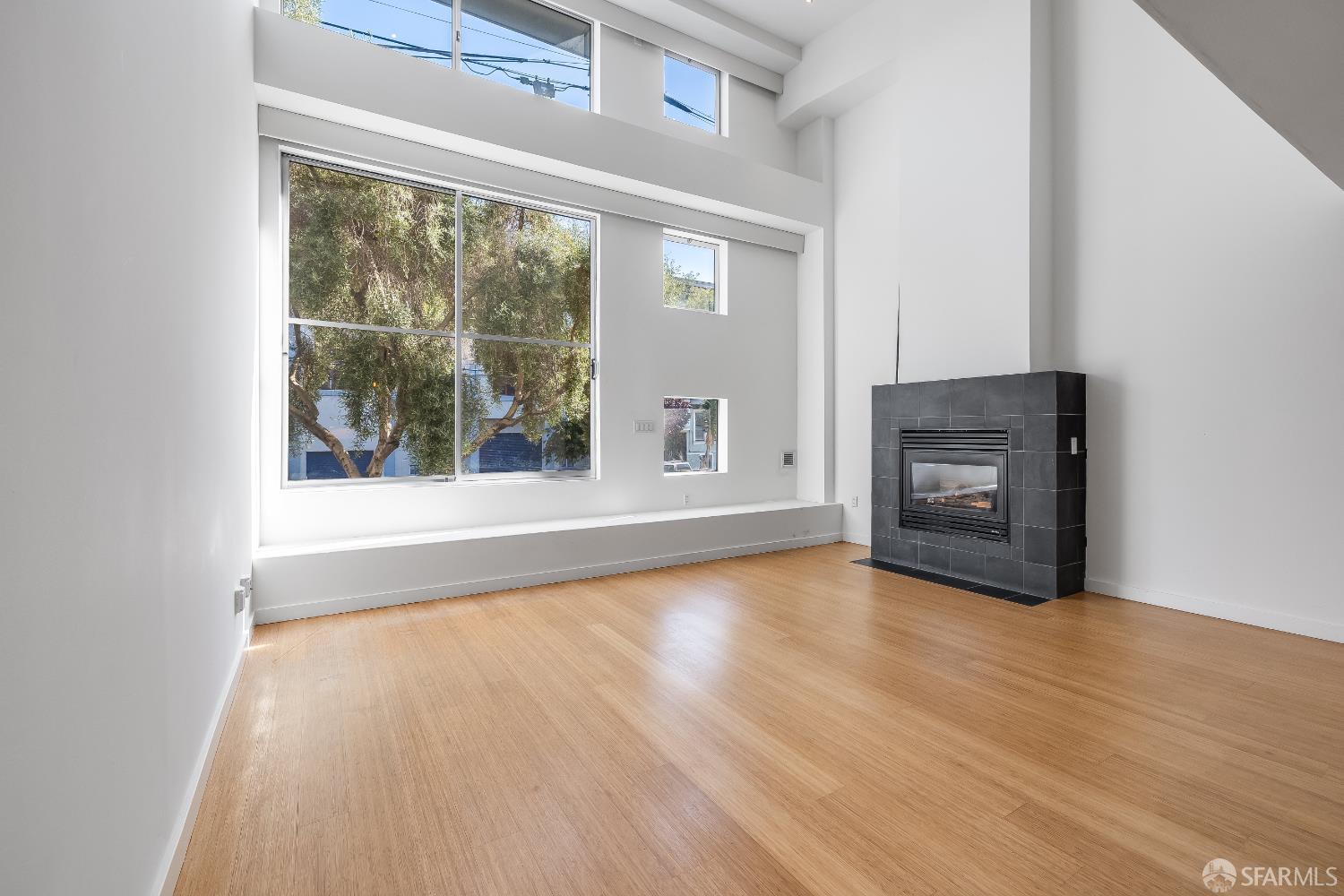 Harrison Street San Francisco, CA 94110 - Photo 4 of 26 a view of an empty room with wooden floor and a window