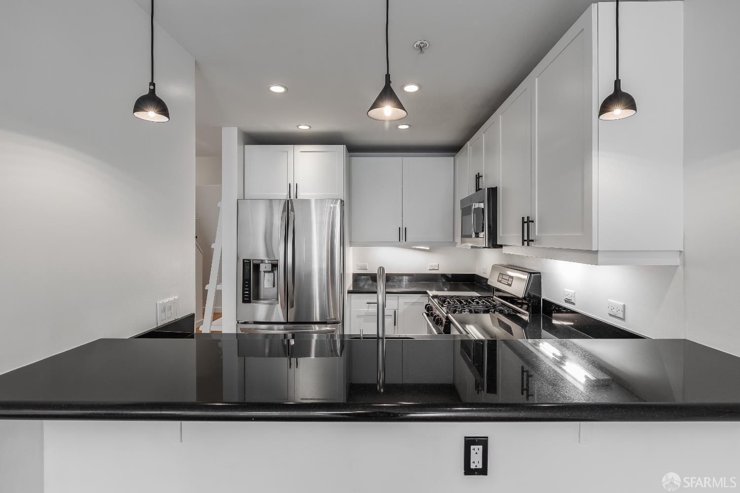 Harrison Street San Francisco, CA 94110 - Photo 8 of 26 a kitchen with kitchen island a sink stainless steel appliances and cabinets