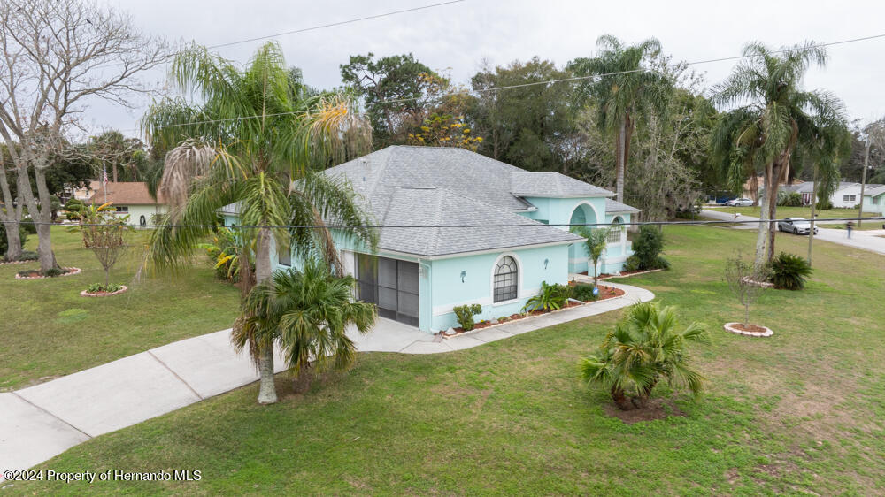 9198 Elida Road Spring Hill, FL 34608 - Photo 32 of 40 a aerial view of a house with swimming pool garden and patio
