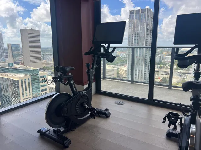 a room with gym equipment and a large window