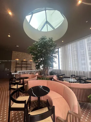 a outdoor space with lots of chairs and a chandelier