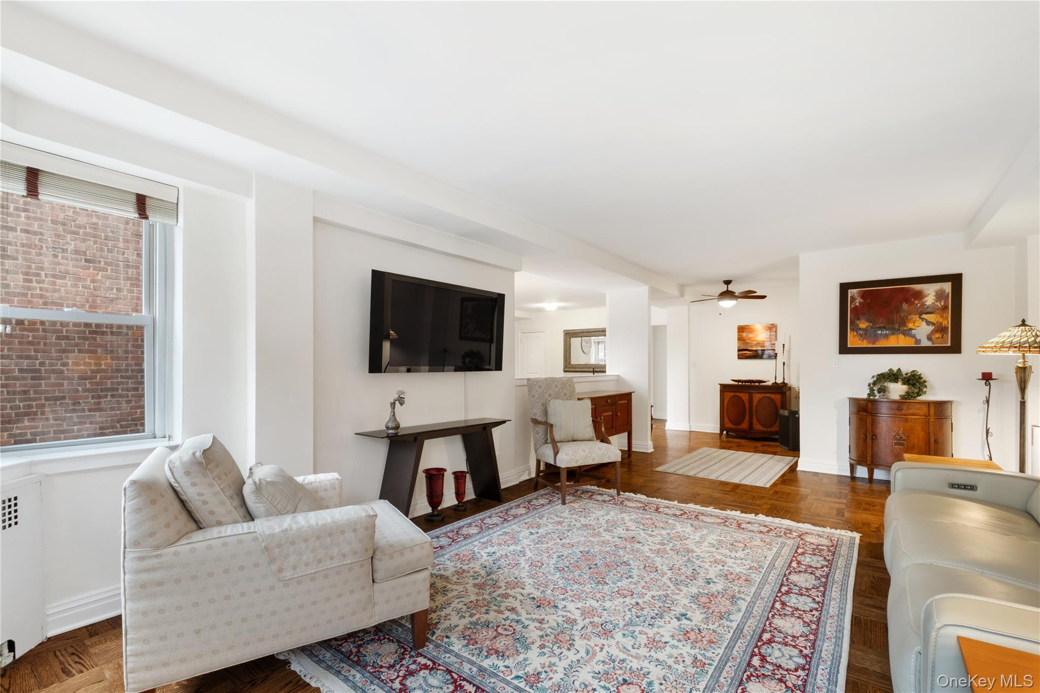 235 Garth Road, Unit E2A Scarsdale, NY 10583 - Photo 12 of 37 a living room with furniture and a flat screen tv