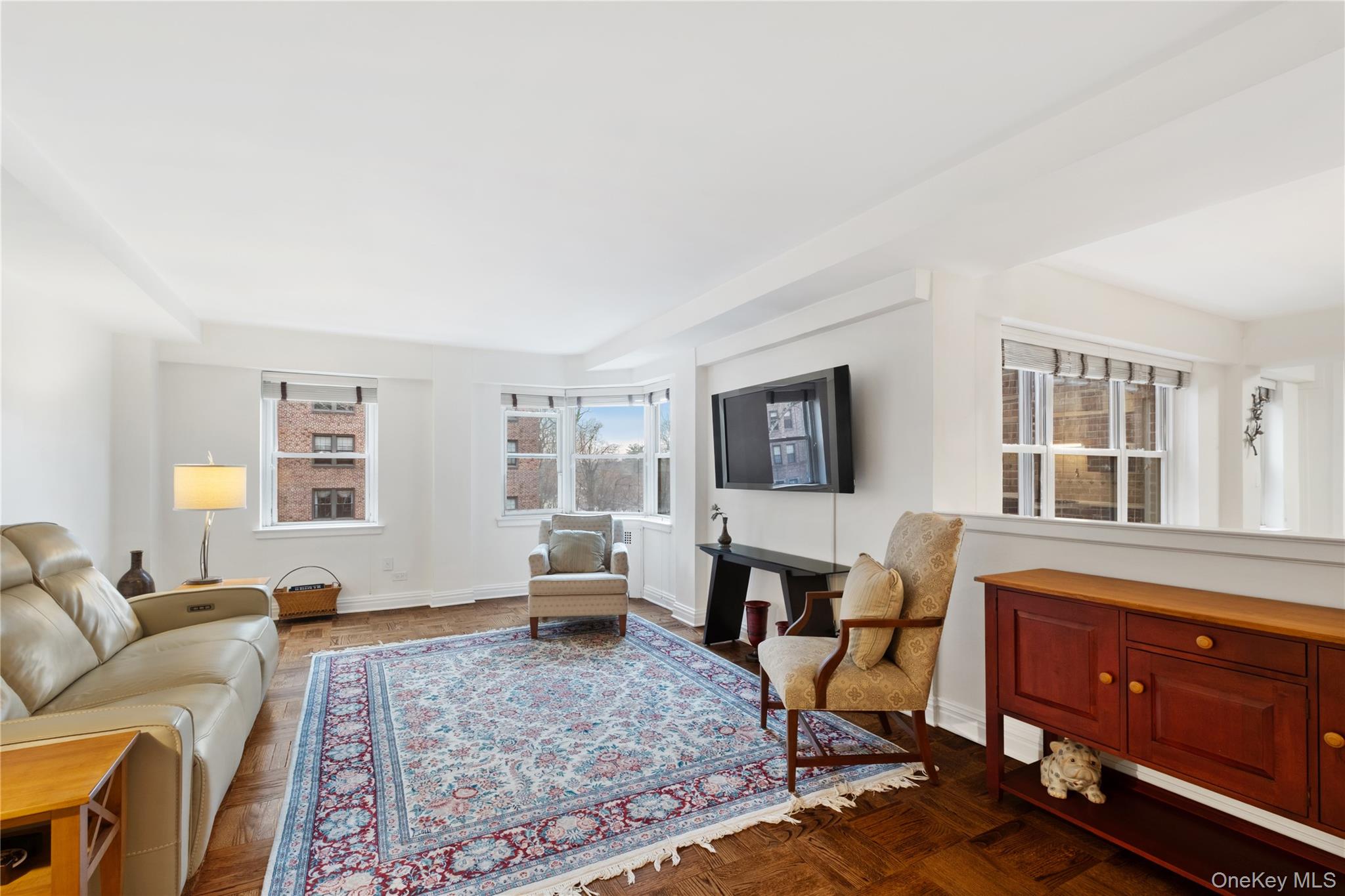 235 Garth Road, Unit E2A Scarsdale, NY 10583 - Photo 15 of 37 a spacious bedroom with a bed a couch and dresser