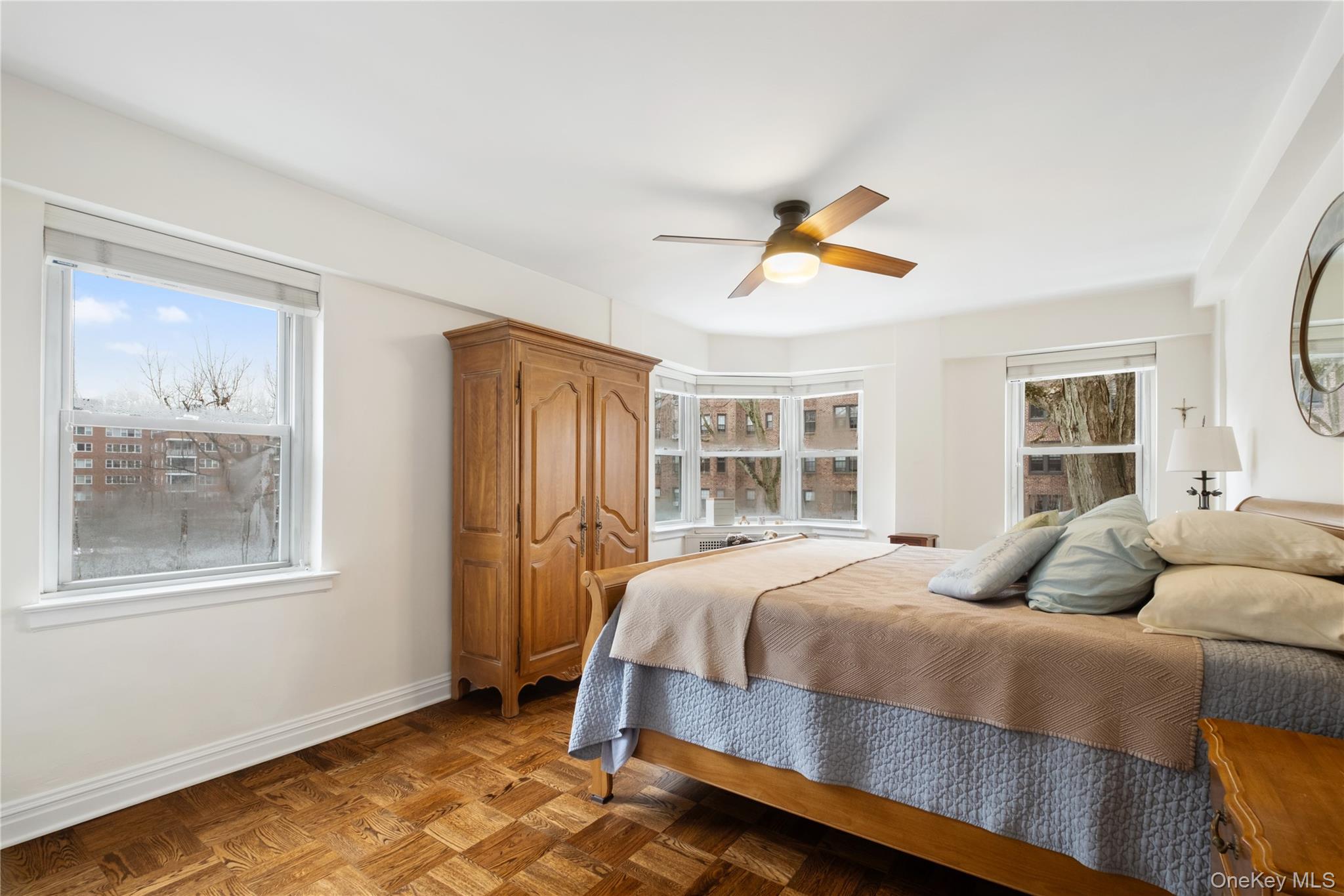 235 Garth Road, Unit E2A Scarsdale, NY 10583 - Photo 19 of 37 a bedroom with a bed and wooden floor