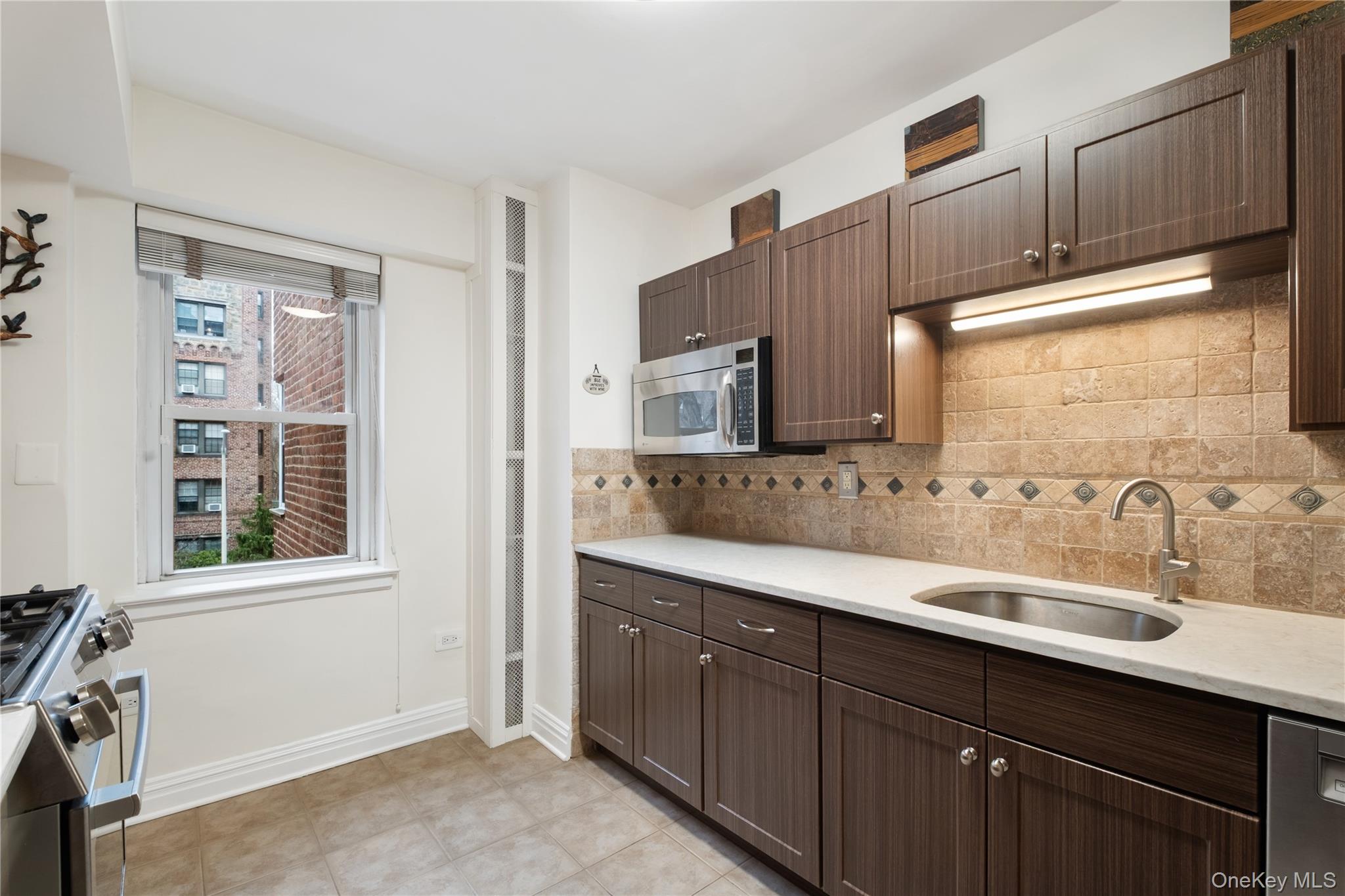 235 Garth Road, Unit E2A Scarsdale, NY 10583 - Photo 2 of 37 a bathroom with a sink double vanity and a mirror