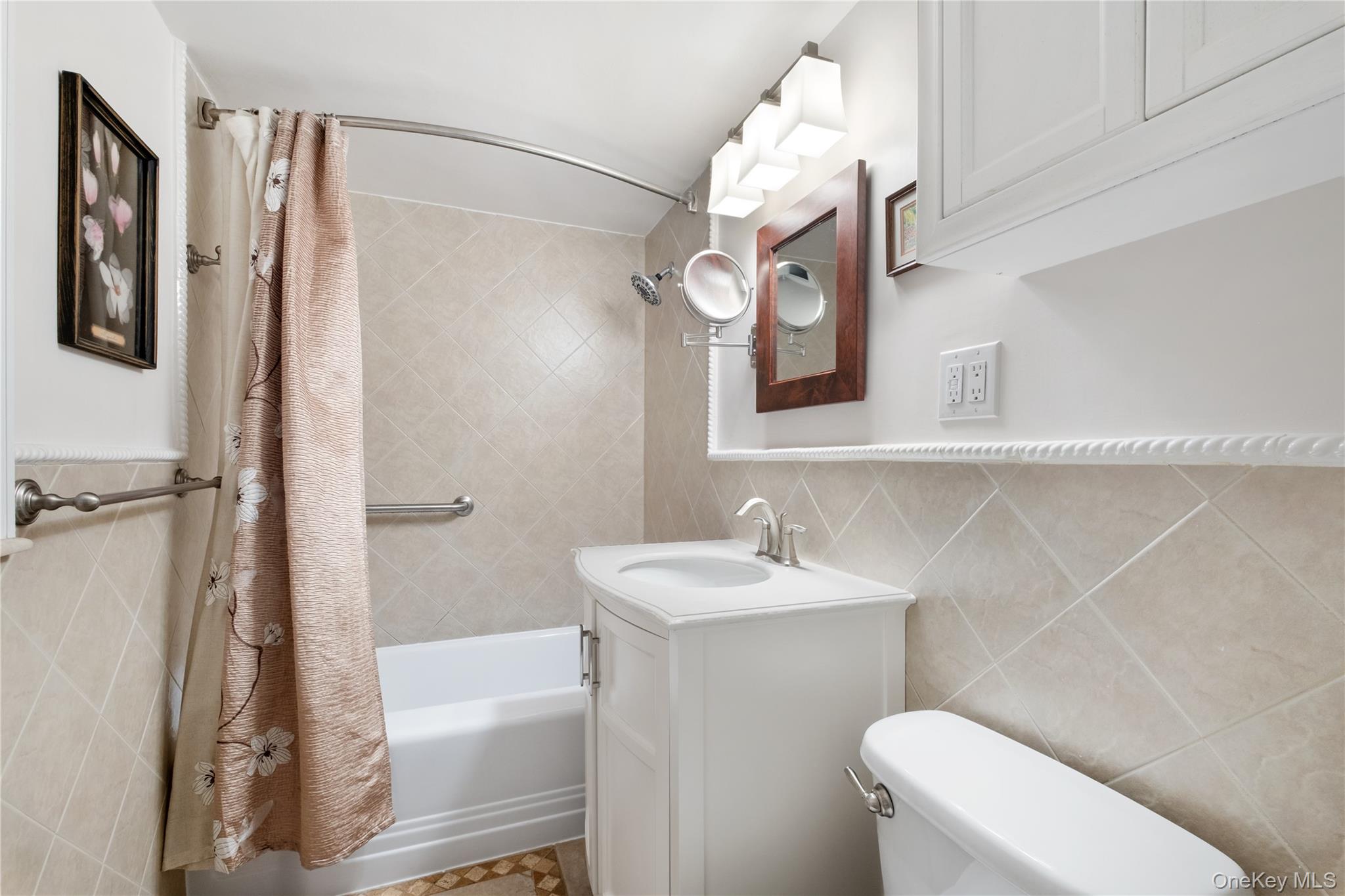 235 Garth Road, Unit E2A Scarsdale, NY 10583 - Photo 22 of 37 a bathroom with a sink a toilet and shower
