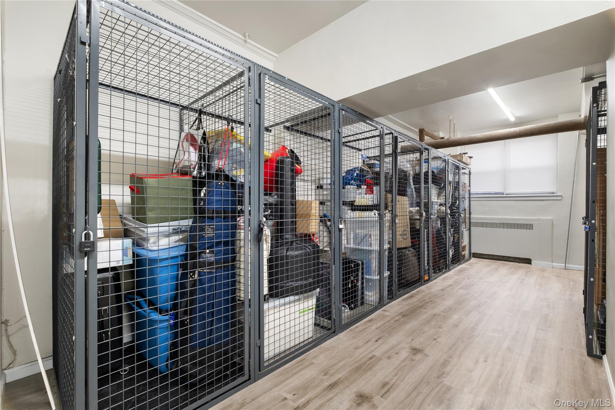 235 Garth Road, Unit E2A Scarsdale, NY 10583 - Photo 29 of 37 a view of water heater room with wooden floor